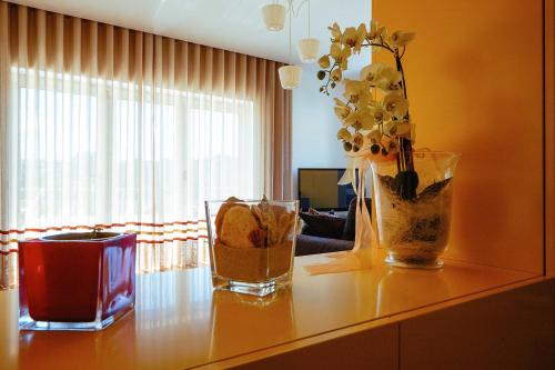 a table with two vases and flowers on it at Casa de Mellares in Melres