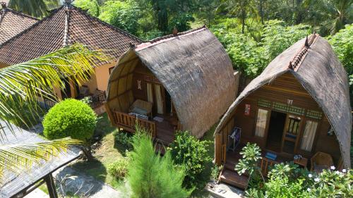 an overhead view of a house with a thatched roof at Bunga Bungalows in Gili Meno