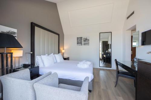 a hotel room with a bed and two chairs at Grand Hotel Amrâth Kurhaus The Hague Scheveningen in Scheveningen