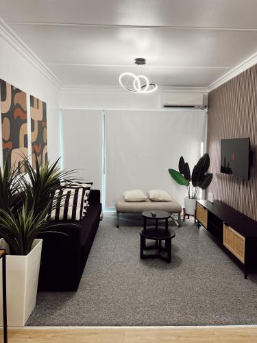 a living room with a couch and a table at Gladstone Gem 9 - Suva CBD 2 Bedroom Apartment in Suva