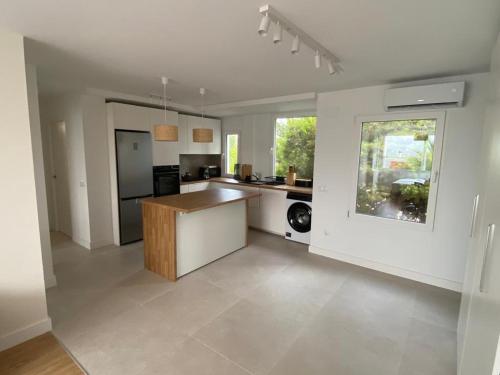 a large kitchen with white walls and a counter at AriaSpot Alicante in Gran Alacant
