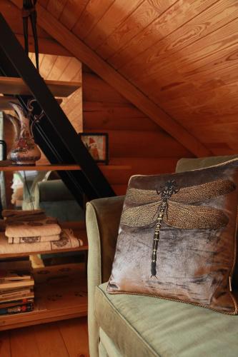 a brown bag sitting on a couch in a room at Pirtis ir nakvynė pajūrio regioniniame parke in Girkaliai