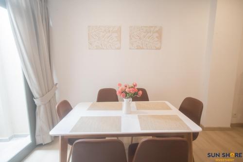 a dining room table with a vase of flowers on it at Old town lofts in Chalkida