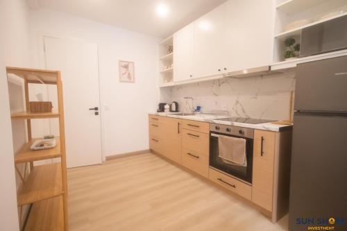 a kitchen with a stove and a refrigerator at Old town lofts in Chalkida