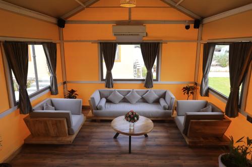 a living room with couches and a table at Kamnath Zinc Journey by The Fern, Diu in Diu
