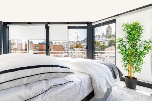 une chambre avec un lit et une grande fenêtre dans l'établissement GuestReady - Paris Charm with Montmartre View, à Paris