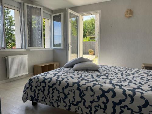 a bedroom with a bed and a large window at Les hyacinthes 6 in Sarlat-la-Canéda