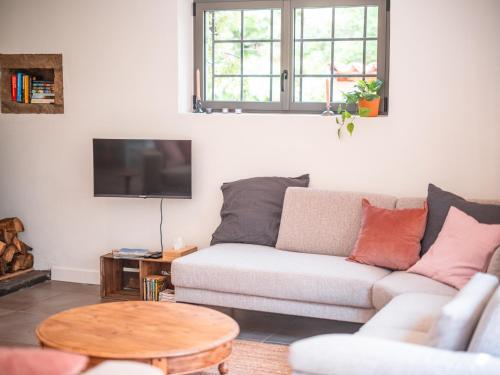 a living room with a couch and a table at L'écrin de Bruniquel in Bruniquel
