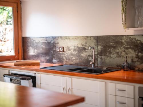 a kitchen with a sink and a counter top at L'écrin de Bruniquel in Bruniquel