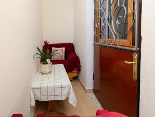 a hallway with a door and a table and a chair at Berat Central Apartment in Berat