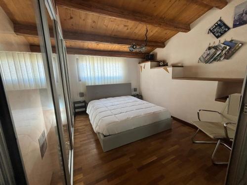 a bedroom with a bed in a room with wooden ceilings at La Meridiana in Augusta