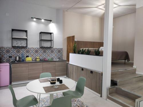 a kitchen with a table and chairs in a room at Al Settimo porta marina in Siracusa