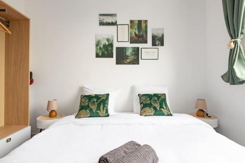 une chambre avec un lit blanc avec deux oreillers dans l'établissement Le charme champêtre, à Toulouse