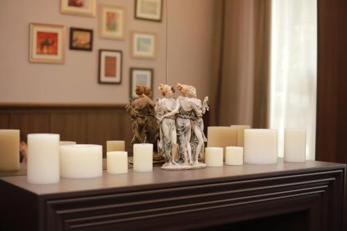 a table with a statue and candles on it at VOGUE HOTEL RESORT AND SPA - Nabran in Nabran