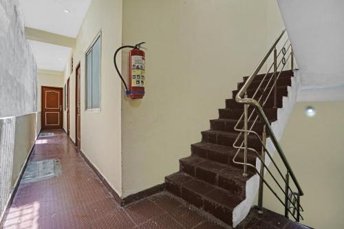 a stairway with a snowboard hanging on a wall at Super OYO Flagship T.Nagar in Chennai