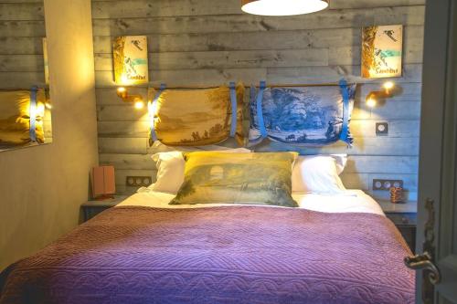 a bedroom with a bed with a wooden wall at Stylish place-Amazing Views-3 main lifts, Apt design- vue splendide-3 Telecabines in Samoëns