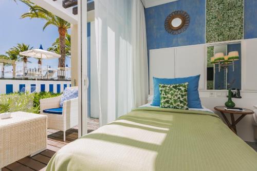a bedroom with a bed and a balcony at Bela Vista Hotel & Spa - Relais & Chateaux in Portimão