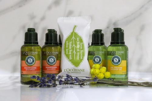 a group of three bottles of hair care products and flowers at Luxury Suite Apartment #66 By Hashdera Eilat in Eilat