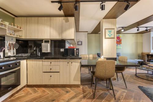 a kitchen with a table and a dining room at Bubble Faraya With Terrasse Next To Ski-Slopes in Fārayyā