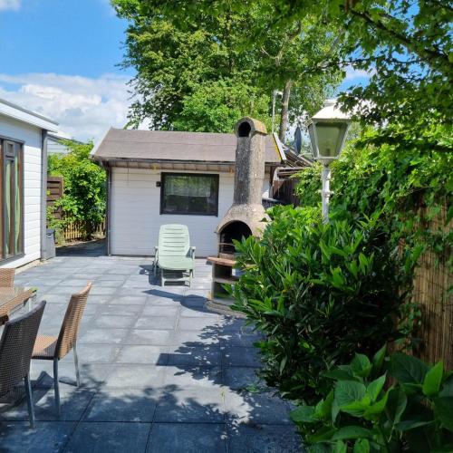 eine Terrasse mit einem Pizzaofen im Hinterhof in der Unterkunft Chalet E 200 de Holle Poarte in Makkum in Makkum