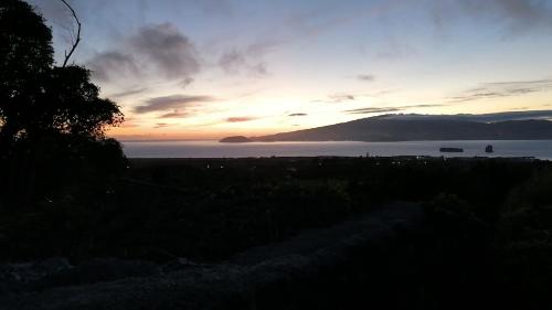 a sunset over a body of water with a mountain at Adega da Quinta - Casa da Gigi in Madalena