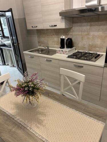 a kitchen with a vase of flowers on a table at Casa Balai in Porto Torres
