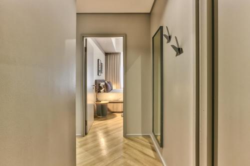 a hallway with a door leading to a bedroom at WINK Aparthotel One Thibault in Cape Town