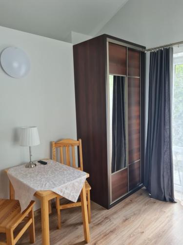 a dining room with a table and a cabinet at Pokoje Gościnne Na Szlaku in Krościenko