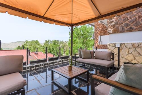 a patio with two couches and a table at Bubble Faraya With Terrasse Next To Ski-Slopes in Fārayyā
