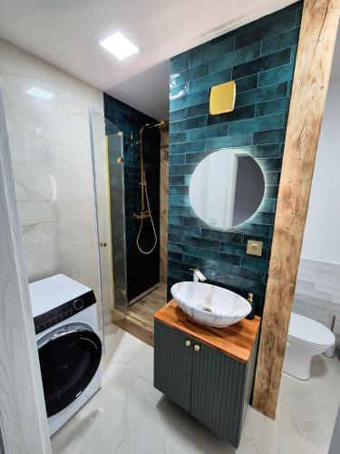 a bathroom with a sink and a toilet and a shower at Apartmán Lesa Brezno in Brezno