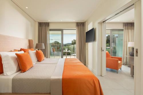 a bedroom with a large bed and a balcony at Rodostamo Hotel & Spa- Adults Friendly in Kommeno