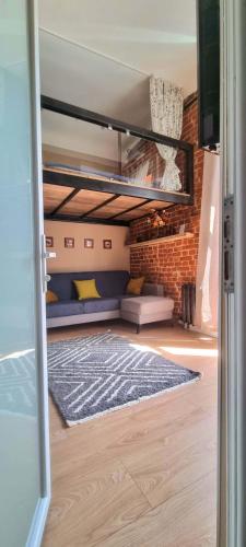 a room with a bunk bed and a couch at Old Town #Menorah #MostCity in Dnipro