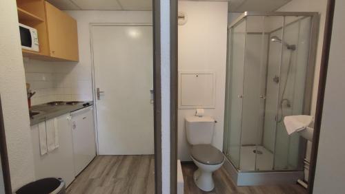 a bathroom with a toilet and a glass shower at Neoresid - Résidence du Parc in Reims
