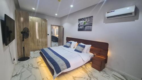 a bedroom with a bed and a air conditioner at Seaview Apartment, Ikoyi in Lagos