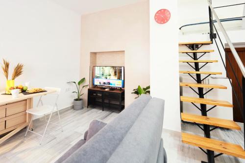 a living room with a staircase and a television at Summerlandrota Veracruz28 in Rota