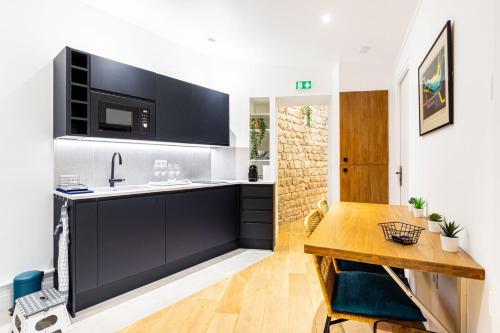 - une cuisine avec un évier et une table en bois dans l'établissement GuestReady - Serene stay near Champ de Mars, à Paris