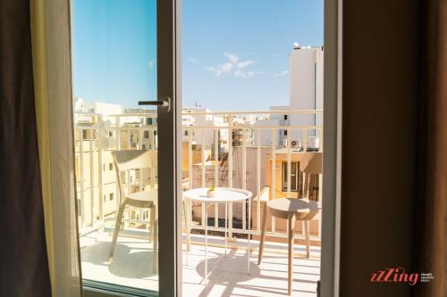 a window with a view of a balcony at Stuart Rooms by Zzzing in Il-Gżira