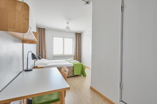 a hospital room with a bed and a window at Töölö Towers in Helsinki