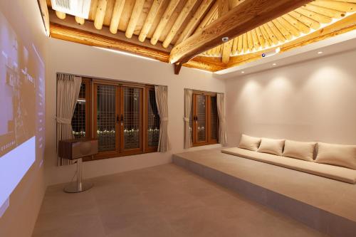 a room with a couch and a tv in it at Cheong-yeon, the Korean traditional house Hanok in Jeonju Hanok Village in Jeonju