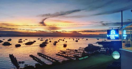 a group of boats in the water at sunset at Hotel Lago Azul in Copacabana