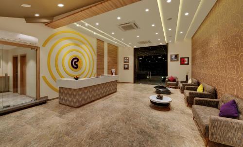a lobby with a waiting room with couches and a bar at Click Hotel Bhuj in Bhuj