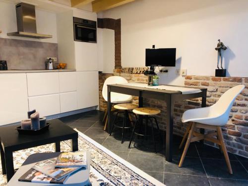 a kitchen with a table and chairs in a room at Hotel de Prince in Nijmegen