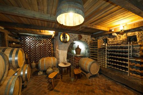 a wine cellar with a bunch of wine barrels at Ratac Eco Guest House in Sutomore