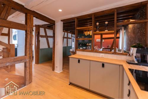 a kitchen with wooden walls and wooden floors at Chez Hansi & Emmy - Gueberschwihr in Gueberschwihr