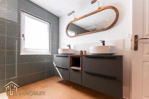 a bathroom with a sink and a mirror at Chez Hansi & Emmy - Gueberschwihr in Gueberschwihr