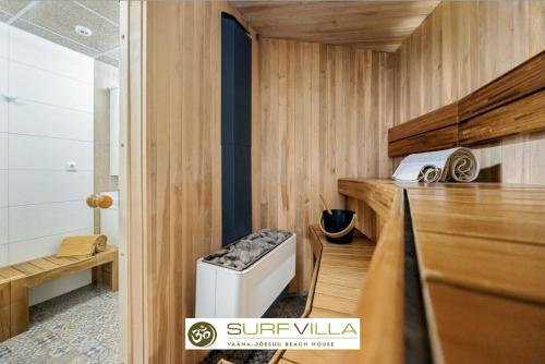a sauna with a washer and dryer in a room at Surf Villa in Vääna-Jõesuu