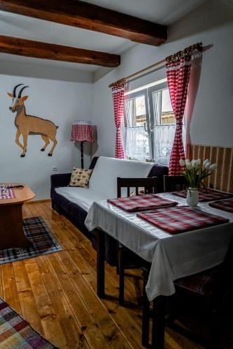 a living room with a bed and a table at Chalupa KLÁRA -Liptov in Ružomberok