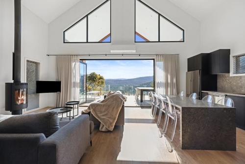 a living room with a table and chairs with a view at Black Tusk - Merrijig - Sleeps 8 in Merrijig