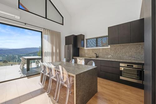 a kitchen with a table and chairs with a view at Black Tusk - Merrijig - Sleeps 8 in Merrijig