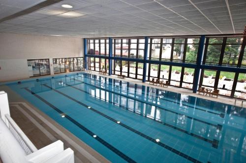 a large swimming pool in a building with a large window at Hotel Samokov in Borovets